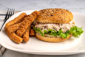 chicken salad  sandwich served  with chicken fries