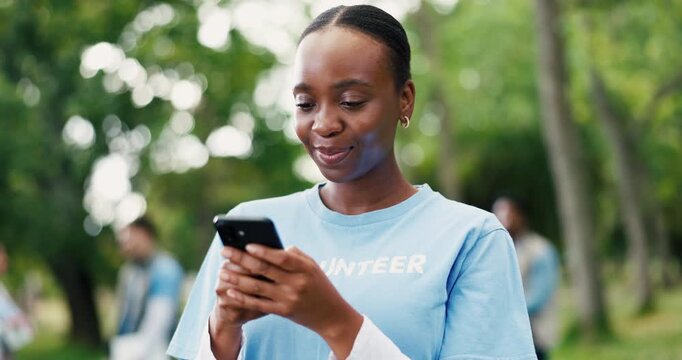 Funny, phone and volunteer woman in park for charity, community outreach or donation update. App, laughing and typing with happy person outdoor for social media post of ngo or non profit mission