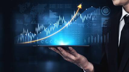 Business professional digitally analyzes financial graphs on a tablet, showcasing a rising arrow which symbolizes growth and success in modern investment approaches. Scalp