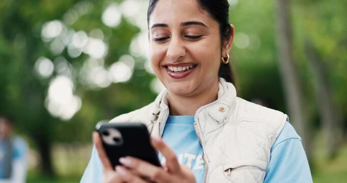 Funny, phone and volunteer woman outdoor for charity, community outreach or donation update. App, laughing and typing with happy person in park for social media post of ngo or non profit mission