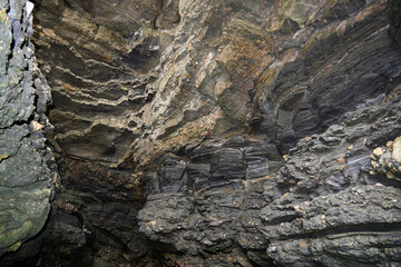 The entrance to a naturally formed cave somewhere on the rocky cliff