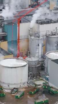 focuses industrial plant factory oudegem belgium steam rising from recycling paper site active processes close up aerial drone panning shot view vpk packaging group 