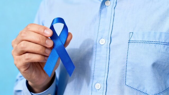 Person holding a blue awareness ribbon against a light blue background