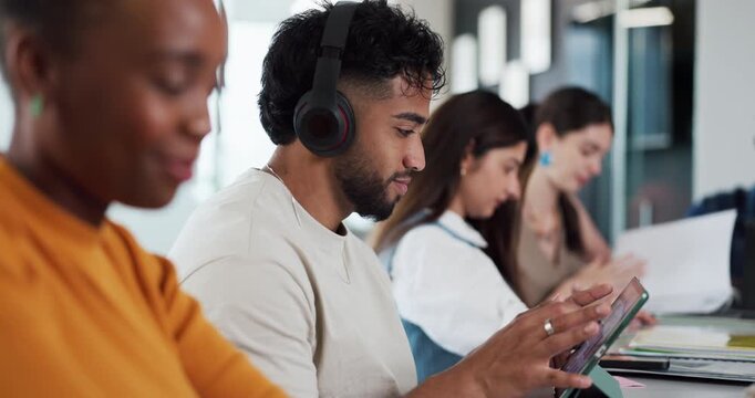 Man, student and headphones with tablet in class for education, study and listening to music. People, coworking and streaming podcast with digital, online learning and course research for assignment