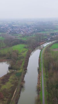 river dender depicted belgian countryside during misty foggy morning green fields serene natural forward aerial drone shot belgium view scenic overview 