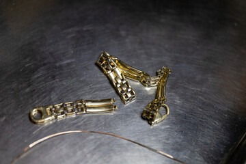 Metallic accessories on a dark surface during a crafting session in the evening