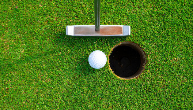 Golf ball putter green grass overhead view crucial putt pristine surface closeup sport competition focus precision outdoor recreation equipment white round hole leisure success challenge aiming