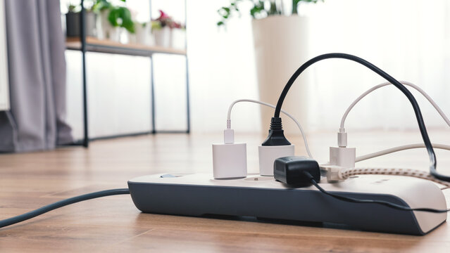 White power strip with a blue cord plugged into it