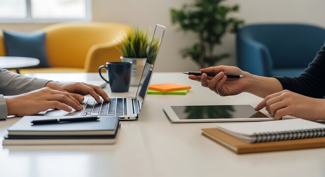 Close up of business people working together in the office, one typing on the laptop and the other handing over a pen, teamwork concept - Powered by Adobe