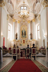 The wedding ceremony takes place in a beautifully decorated church with a serene atmosphere and elegant details.
