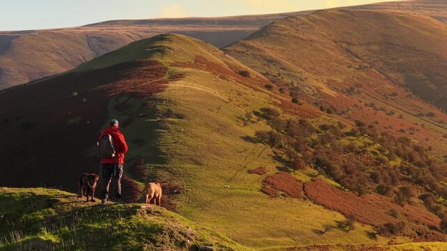 Dragons Back Brecon Beacons man stood overlooking the dragons back known as Waun Fach loop hiking route during a sunrise morning
