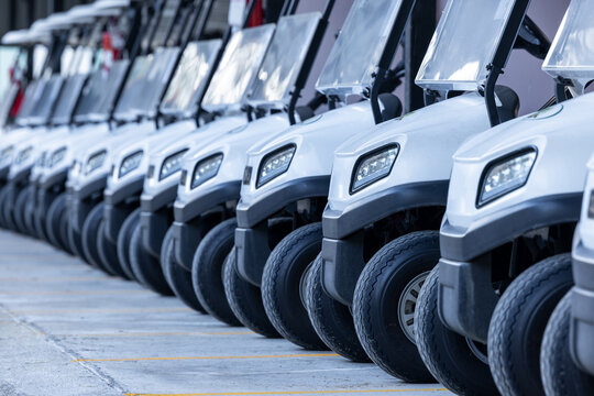 Row of new golf carts for golf player, Golf course carts cars at luxury resort sport, Golf cars in a row on golf course, Row of golf carts.