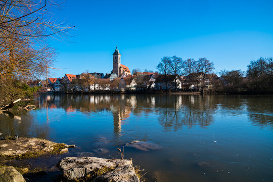 Germany, Beautiful skyline houses church steeple of nuertingen city reflecting in river water with blue sky in winter mood panorama