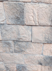 Stone wall texture close up light gray masonry vertical