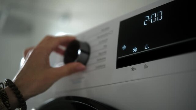 Woman In The Bathroom Starting A Modern Drying Machine And Choosing A Drying Cycle