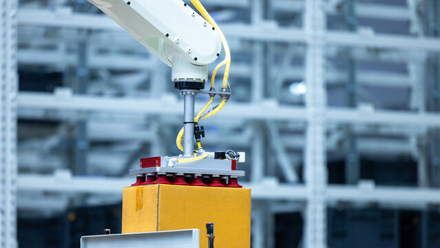 Robotic arm handling boxes on pallets in automated warehouse, Logistics warehouse automation robotics, Robotic arm automated factory packing system efficient industrial box handling and logistics
