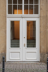Elegant white double doors invite with their clean lines and glass panels.