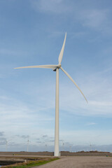 Fototapeta premium Wind Turbines power the future with renewable energy in a field setting.