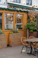 Charming outdoor seating area with wooden accents and festive decorations.