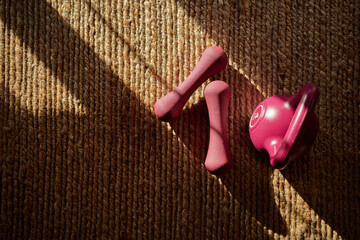 Fitness equipment arranged on a textured floor during bright daylight showcasing workout tools for strength training