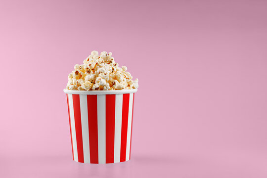 Classic red striped popcorn cardboard cup on Red background