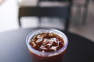 Closeup of a glass of iced coffee on the table in cafe
