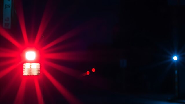 fracas. Emergency vehicle lights cast abstract blue and red patterns on a dark, atmospheric street at night. mobility guides, transit brochures, designed for mobility and urban transit guides.