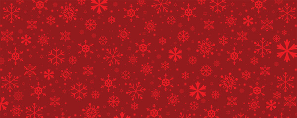 A seamless, festive pattern background composed of various sizes and styles of monochromatic red snowflakes on a deep red backdrop. This repeating texture is ideal for Christmas, winter, and holiday-t