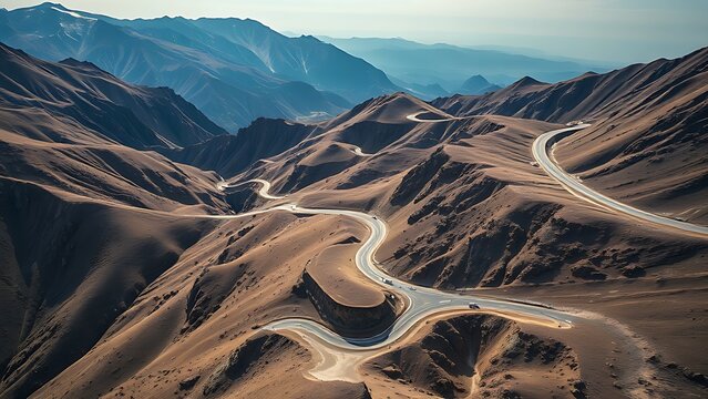 conductance. Aerial view of a winding mountain highway cutting through rugged terrain. travel magazines, destination branding, designed for outdoor magazines and nature guides.