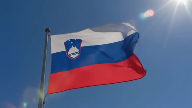 Slovenian flag waving proudly in the bright sunshine, representing national pride and patriotism in a vibrant display of color and movement