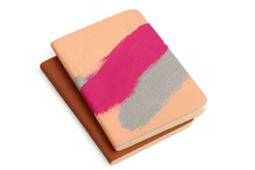 Stacked notebooks with hand painted covers, art supplies representing creativity, ideas, and journaling on transparent background