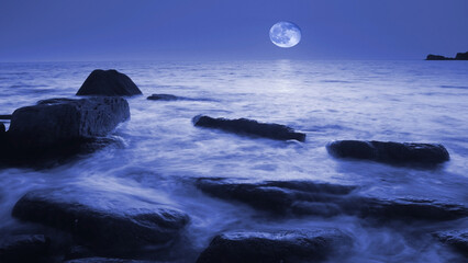 Moonlight over the sea in the Exmoor National Park , Devon , UK