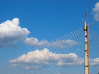 Construction of a large bridge. Cable stayed bridge in Belgrade, Serbia. Part of the Ada bridge beautiful sky with cloud background, Selective focus.