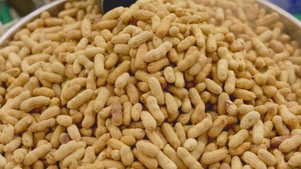 Peanuts on stall, street vendor serving roasted peanuts at festival, festival stall with roasted peanuts and festive ambiance, local fair evening with vendor serving crunchy roasted peanuts, concept