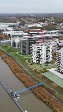 new development area de zaat temse belgium scene includes riverside apartments historic boelwerf crane scheldt river forward aerial drone shot view cordeel headquarters 