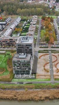 new development area de zaat temse belgium scene includes riverside apartments historic boelwerf crane scheldt river backward aerial drone shot view urban landscape waterfront 