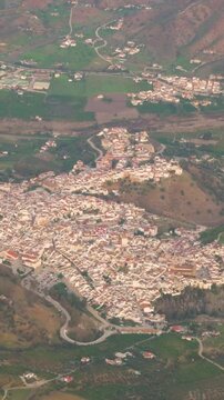 from inside airplane passenger window alora village town spain aircraft approaches airport for landing aerial view spanish approach rural landscape 
