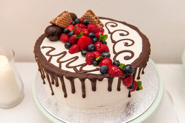 White cake with chocolate and berries