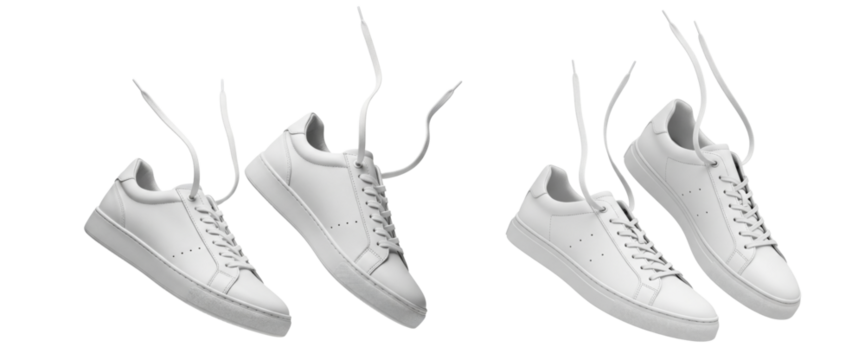 Set of white leather sneakers with untied shoelaces floating in the air isolated on white