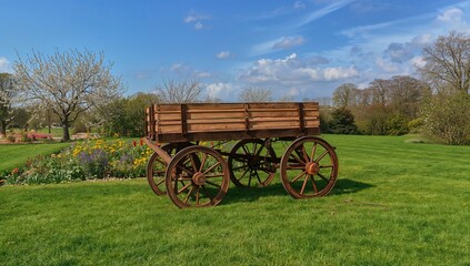 A wheeled garden cart filled with freshly cut grass, ideal for lawn maintenance