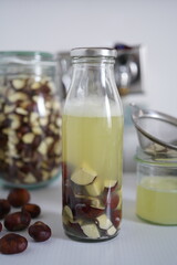 A glass bottle filled with homemade liquid detergent made from horse chestnuts and water. Eco-friendly, biodegradable, and zero waste cleaning product.