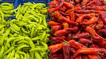 Colorful Display of Fresh Green and Red Peppers in a Market Stall, Showcasing Vibrant Produce and Healthy Options