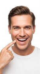 A radiant and joyful young man with a perfect, healthy smile points to his happy face, expressing genuine happiness and satisfaction on a clean white background, showcasing positive well-being