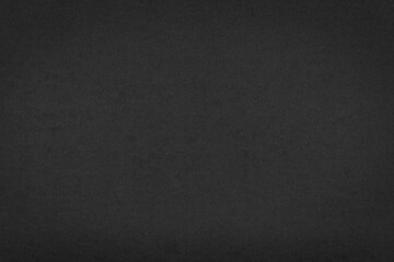 Dark grey paper texture background closeup.