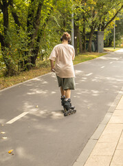 Person rollerblading on a park path active leisure vertical