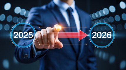Businessman touching screen indicating progress from year 2025 to 2026 with red arrow