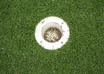 Mini golf hole on artificial turf close up horizontal