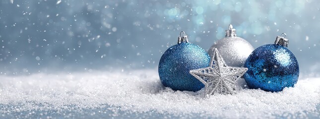 Elegant christmas background with blue and silver ornaments in snow setting for festive design