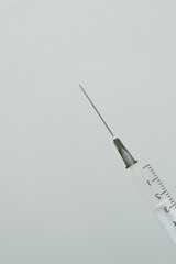 A medical syringe with a needle placed on an isolated background. Concept A sterile injection tool presented for healthcare-related use.