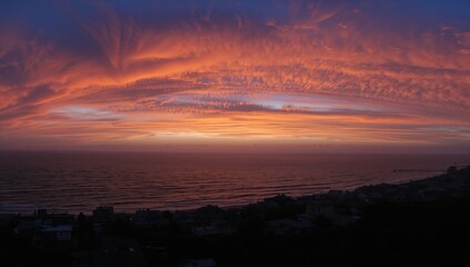 Obraz premium Dawn fire panorama illuminating a coastal area, showcasing seasonal change